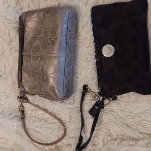 One silver and one black  Coach wristlet